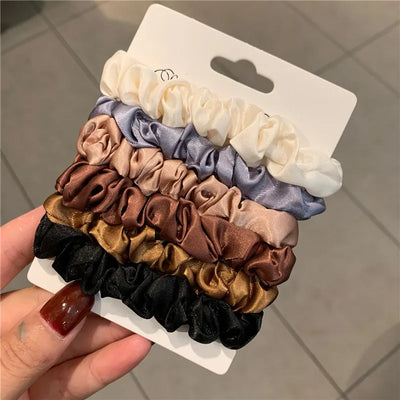 Set of 6 minimalist silk hair scrunchies in solid colors, displayed on a white card. Elegant and elastic hair ties for women’s ponytail styling.